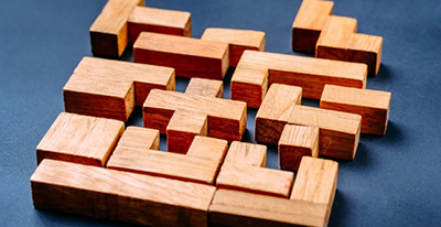 different-geometric-shapes-wooden-blocks-dark-background_77190-3013